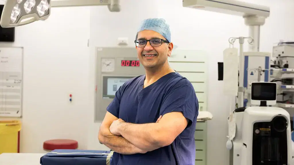 Smiling Mr Kumar in scrubs