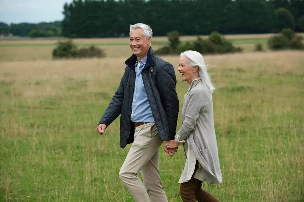 Couple taking a walk carefree after private knee replacement