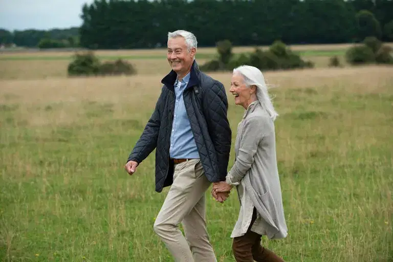 Couple taking a walk carefree after private knee replacement